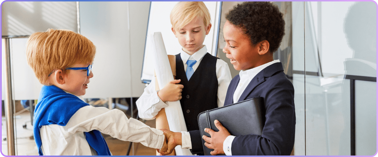 Three young students in business attire shaking hands
